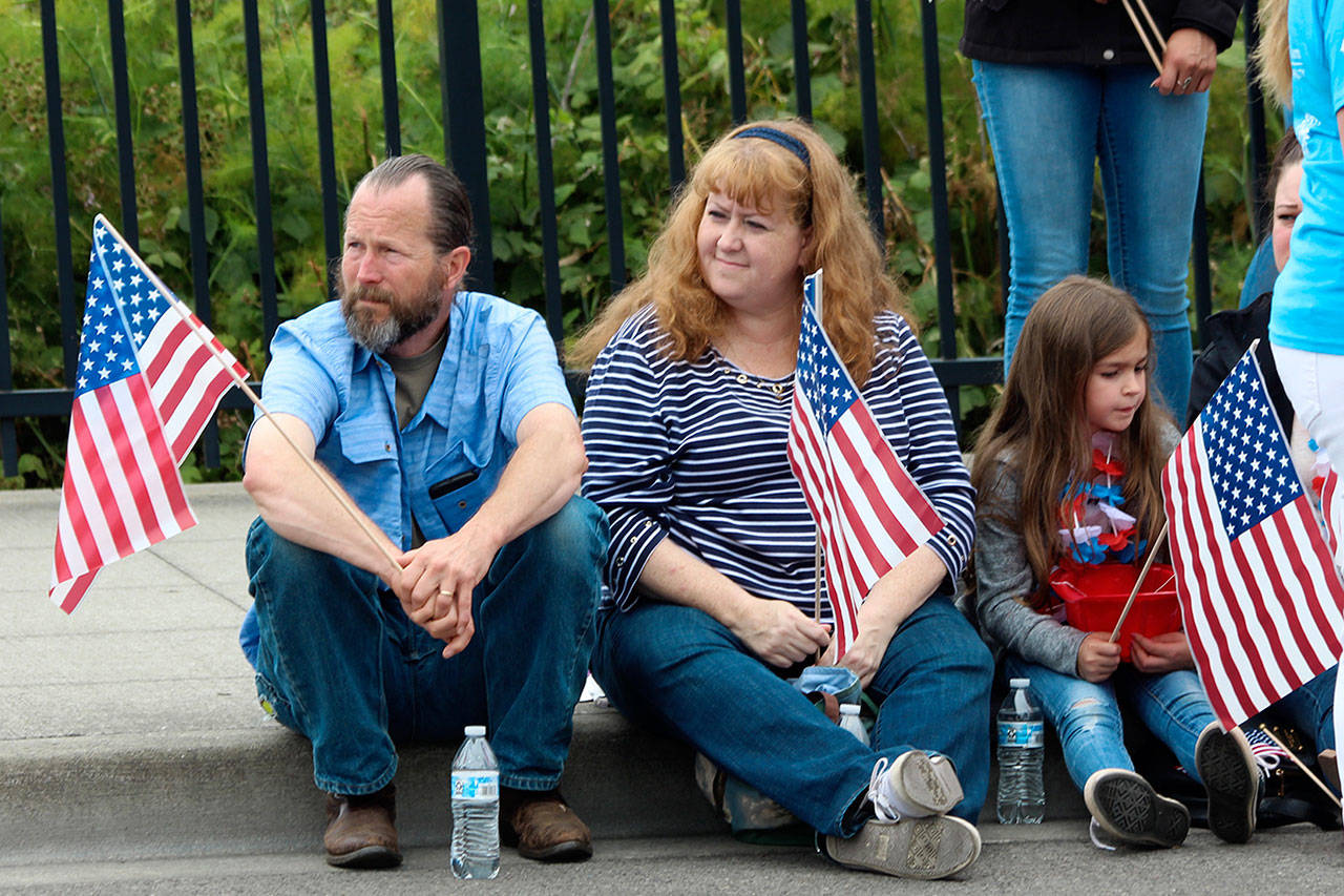 Bill and Elva McArthur of Oak Harbor watch the parade proceed with their niece, Olivia Santibanez.