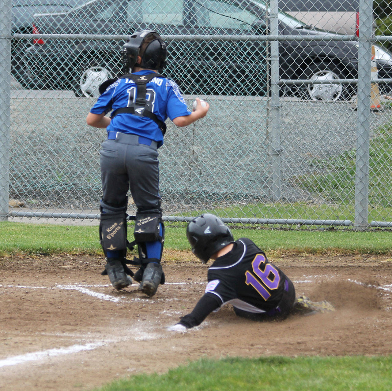 Dylan Ebersberger slides in a force play at the plate.(Photo by Jim Waller/Whidbey News-Times)