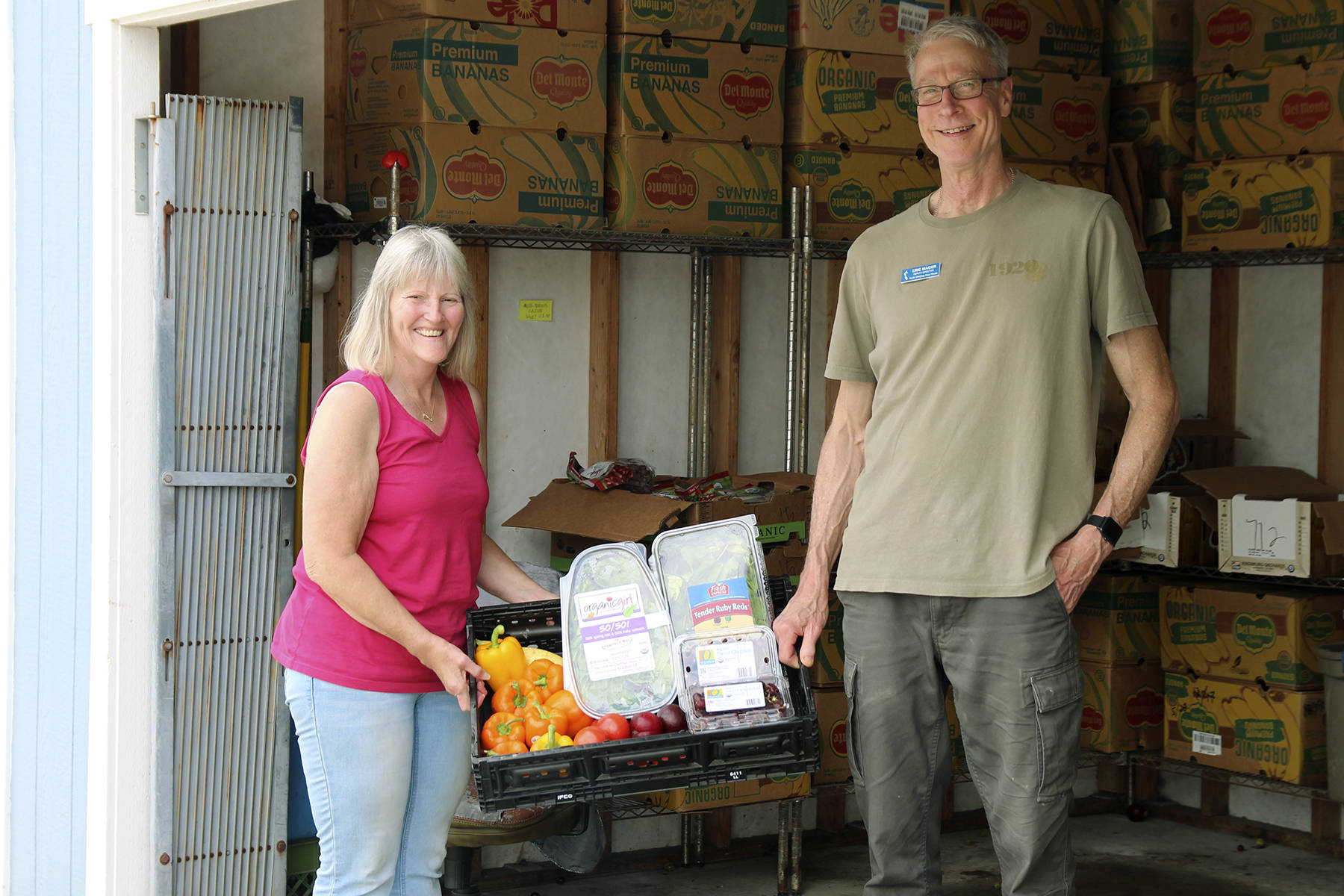 Executive Director, Jean Wieman and Deputy Director Eric Mager with a selection of donated produce. The community has donated hundreds of pounds of produce in the past six weeks, including store-bought and home-grown. North Whidbey Help House staff are preparing for the annual summer food drive on July 13.                                (Photo by Maria Matson/Whidbey News-Times)