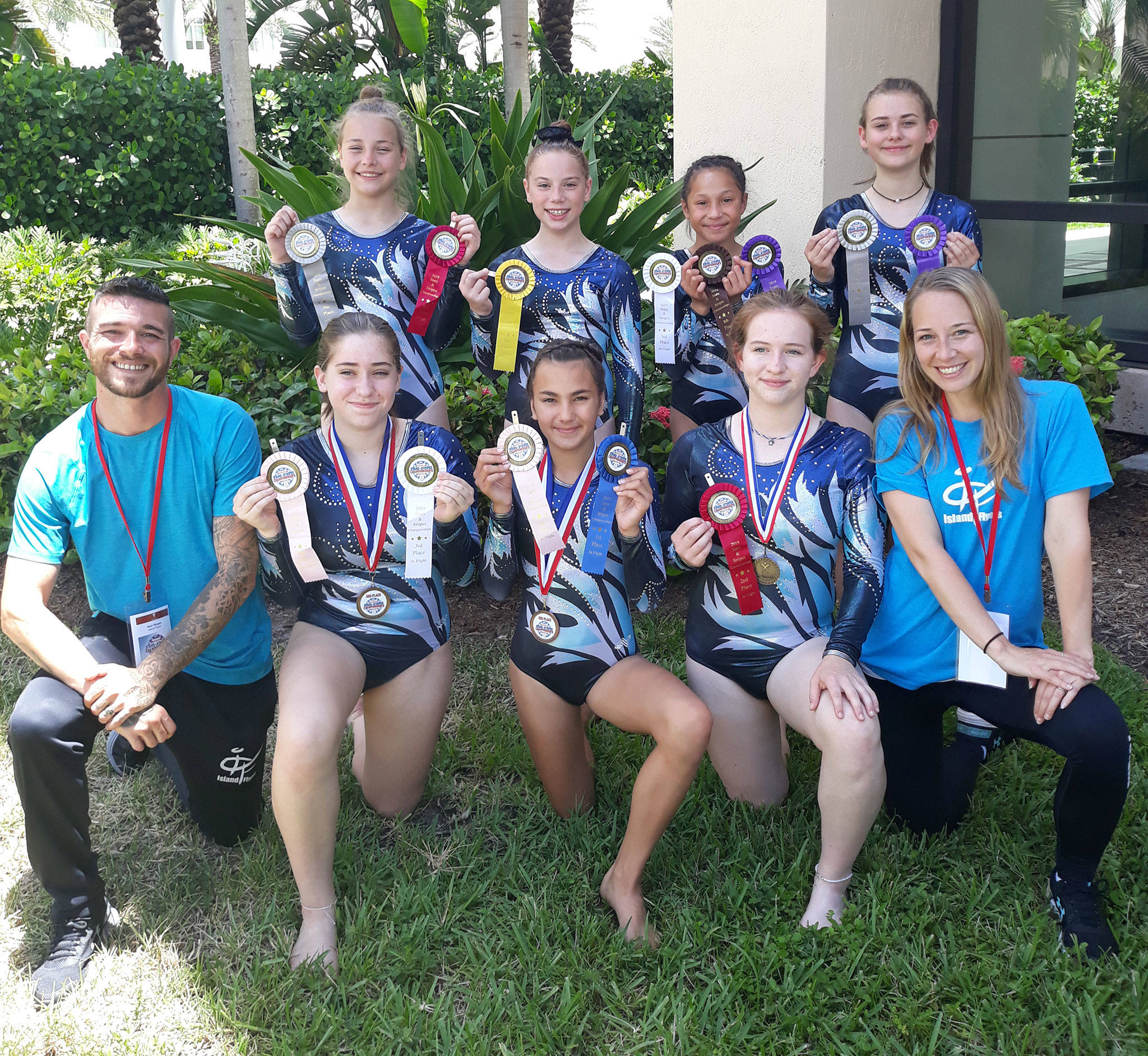 The Island Flyers show off the medals they won at the national championships last weekend. Front row, left to right: coach Sean Reagan, Catrina Ocanas, Keira Smith, Cassidy Gore and coach Melody Reagan. Back row: Harmony Wertz, Madison Walker, Arianna Hunt and Leighlah Louis. (Submitted photo)