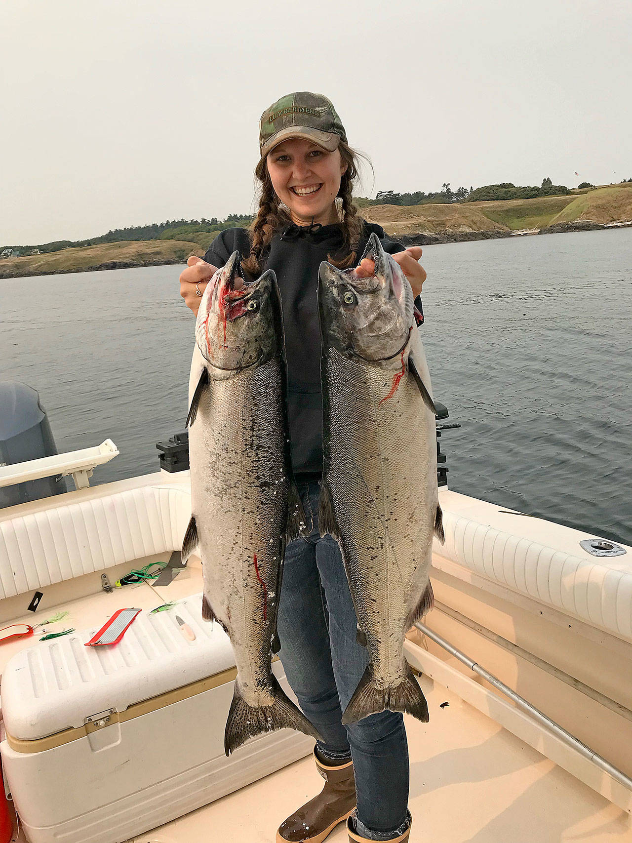 Coupeville resident Kelsey Miranda holds two salmon that she caught off the shores of Whidbey Island. Photo provided