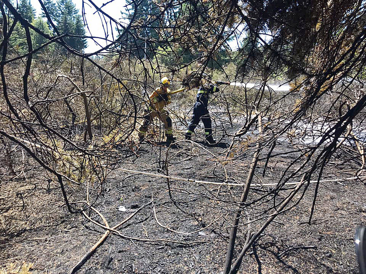 South Whidbey Fire/EMS firefighters extinguish a brush fire near Humphrey Road last week. Photo provided