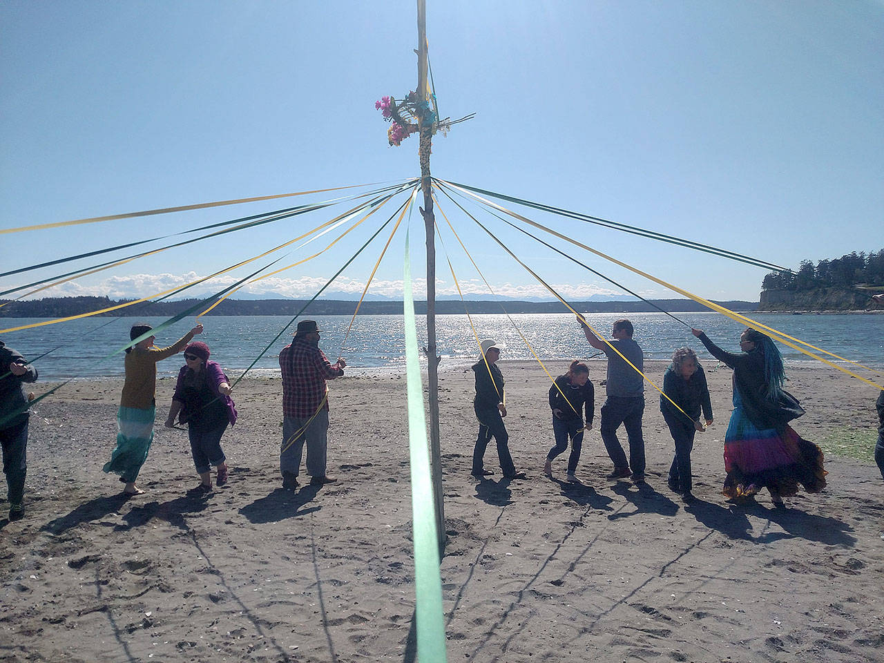 Photo submitted                                Members of the group Whidbey Witches, Heathens, Druids & Pagans celebrate with a maypole on the beach. The group is holding a pagan pride festival this weekend.