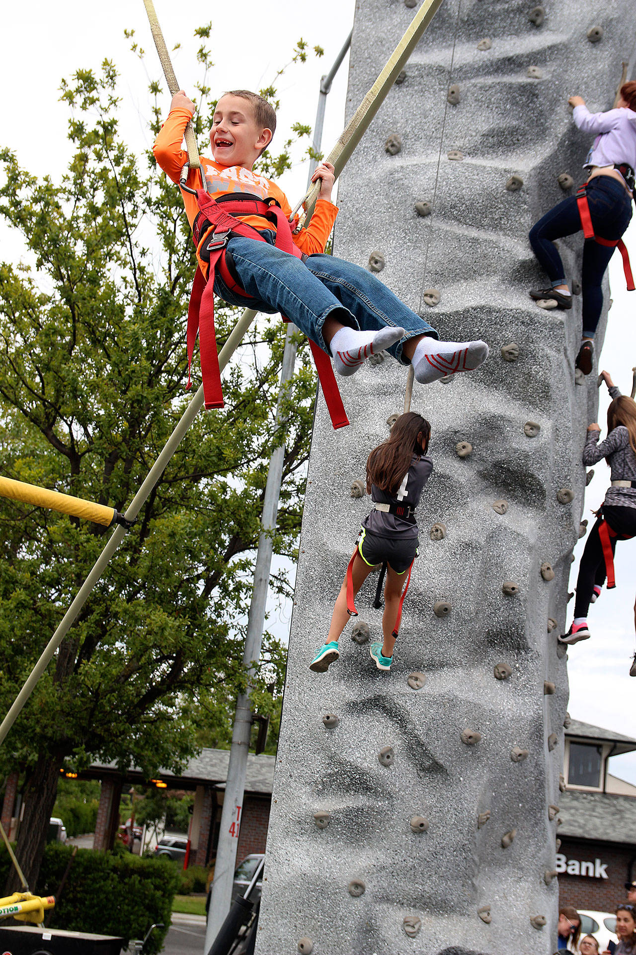Aidan Wawro, 7, jumps from a trampoline and is hoisted by bunjee cords Sunday afternoon at Oak Harbor’s annual Pigfest. (Photos by Laura Guido/Whidbey News-Times)