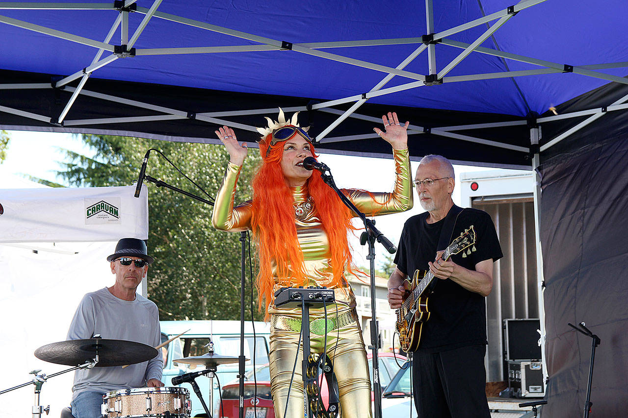 Piper Reva, lead singer of Piper and the Planets, performs with bandmember Steve Trembley, on guitar, and Mike Smith, drums at the Coupeville Arts and Crafts Festival Saturday.