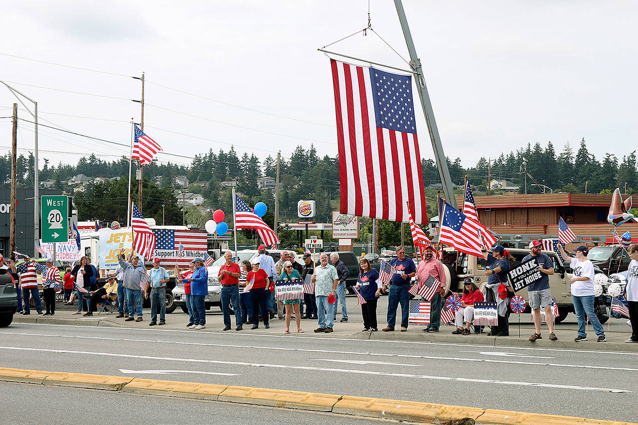 Navy supporters wave their signs to passing cars on Highway 20 in Oak Harbor Saturday afternoon. (Photos by Laura Guido/Whidbey News-Times)