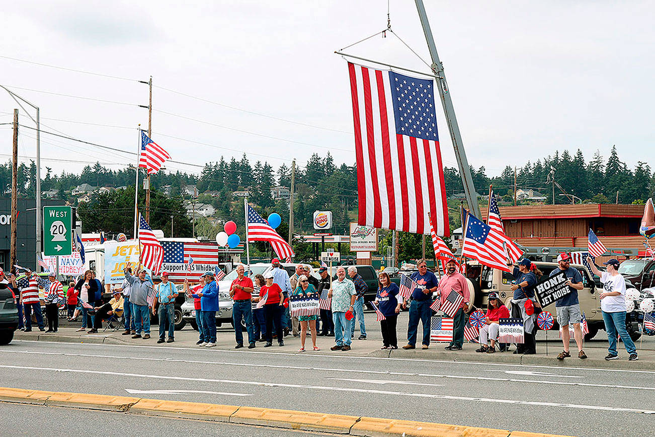 Supporters wave flags and signs in support of Navy at weekend rally