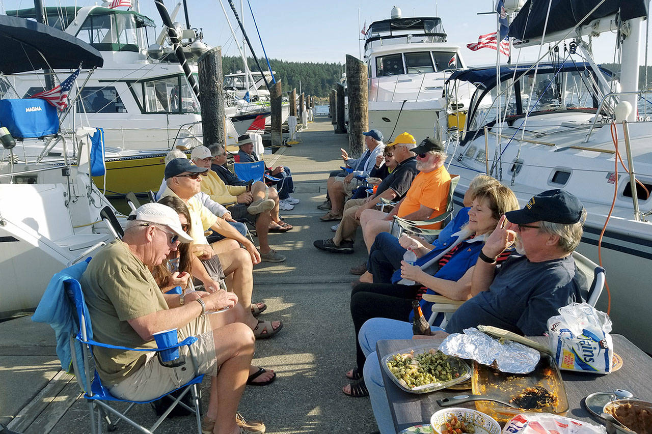 Boaters swap boating and “whale tales” on a beautiful day at recent dock party.