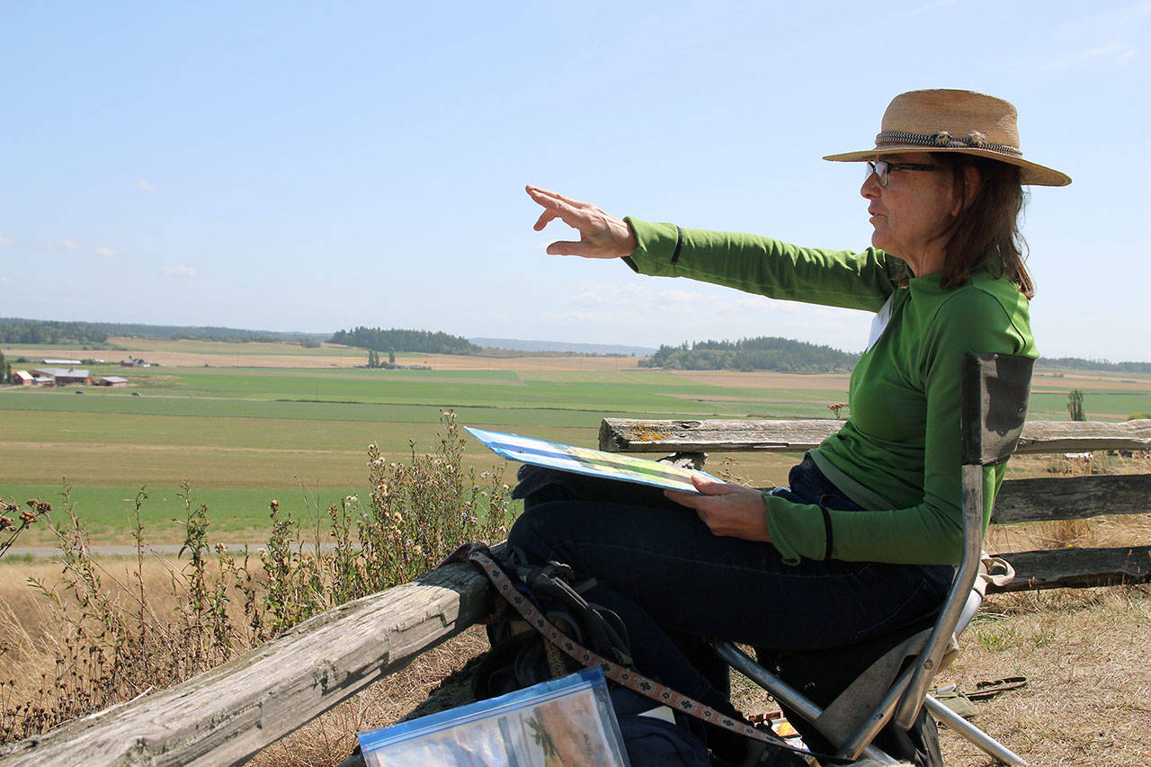 The scenic view of Ebey’s Reserve serves as inspiration for watercolor artist Susan Payne, who participated in this week’s “paint out” events leading up to the Whidbey Plein Air exhibition this weekend. Photo by Maria Matson/Whidbey News Group
