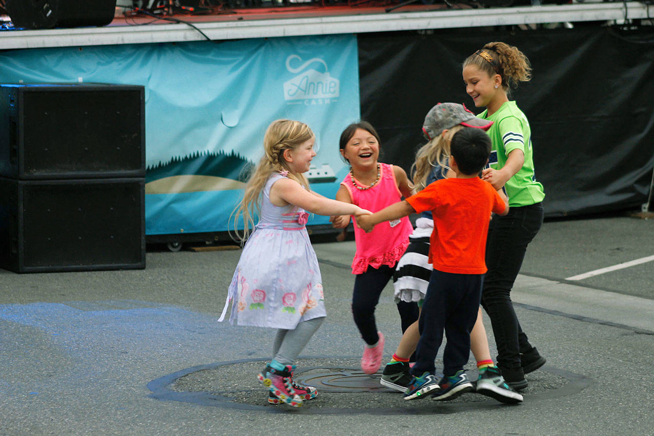 Children move to the music in front of the east end Peoples Bank Stage.                                (Photos by Maria Matson/Whidbey News-Times)