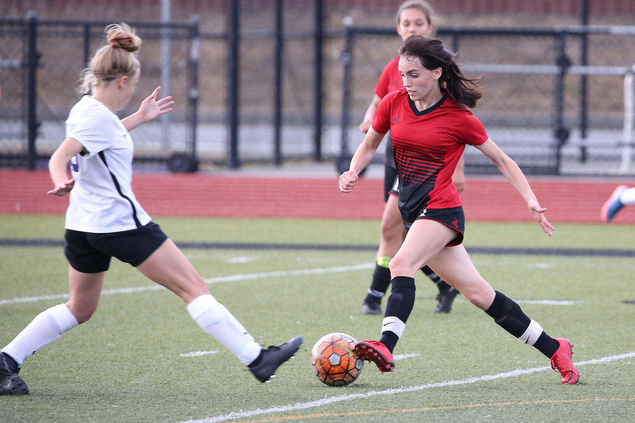 Mallory Kortuem, right, gets to the ball first for Coupeville in Thursday’s jamboree.(Photo by John Fisken)