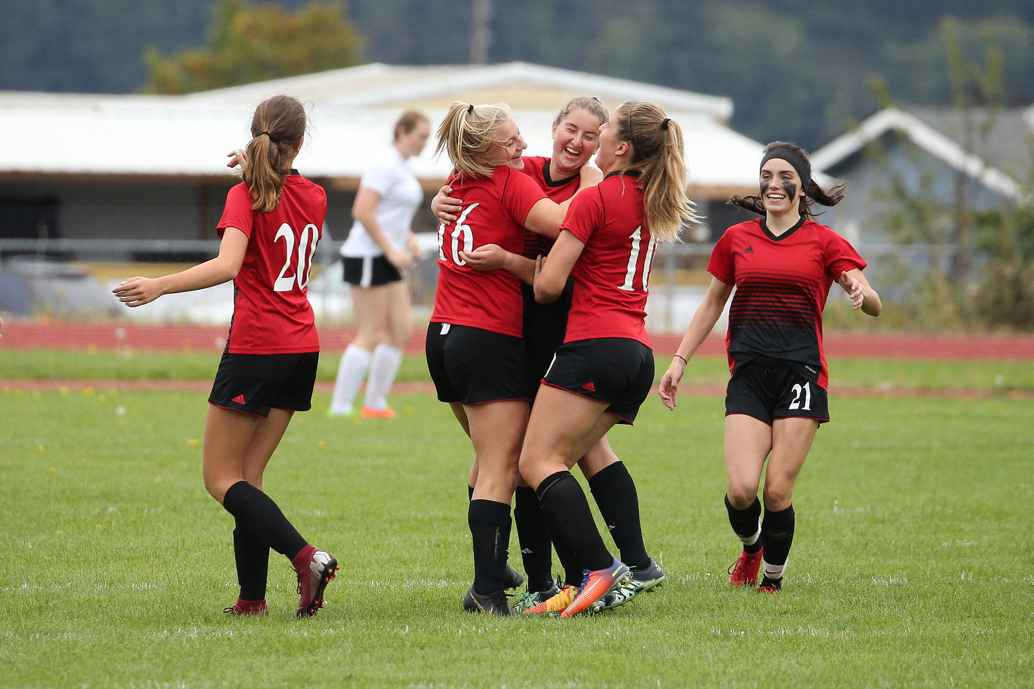 Coupeville’s Avalon Renninger (16) celebrates with her teammates after scoring for the Wolves. (Photo by John Fisken)
