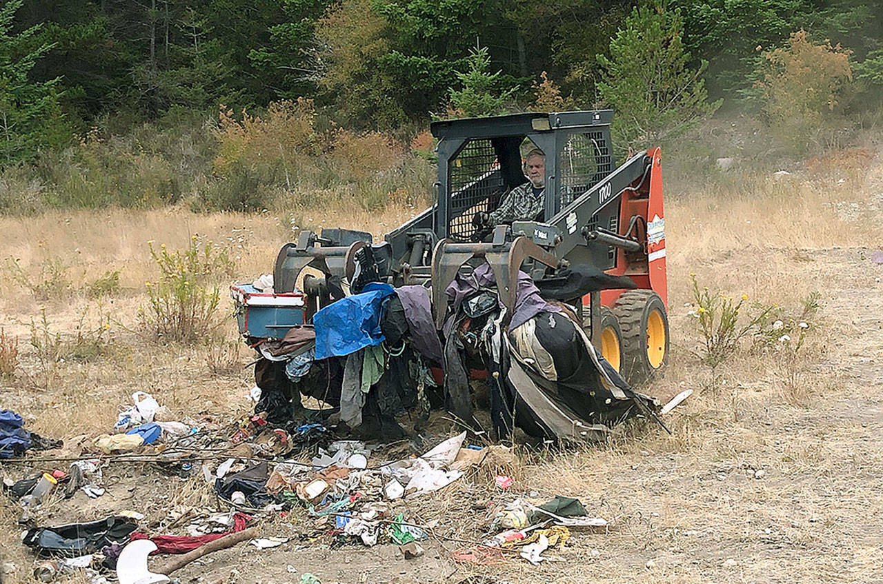 Steve Mong, of Clutter Cops, clears debris in an area off Goldie Road often referred to as “the pit.” Photo provided