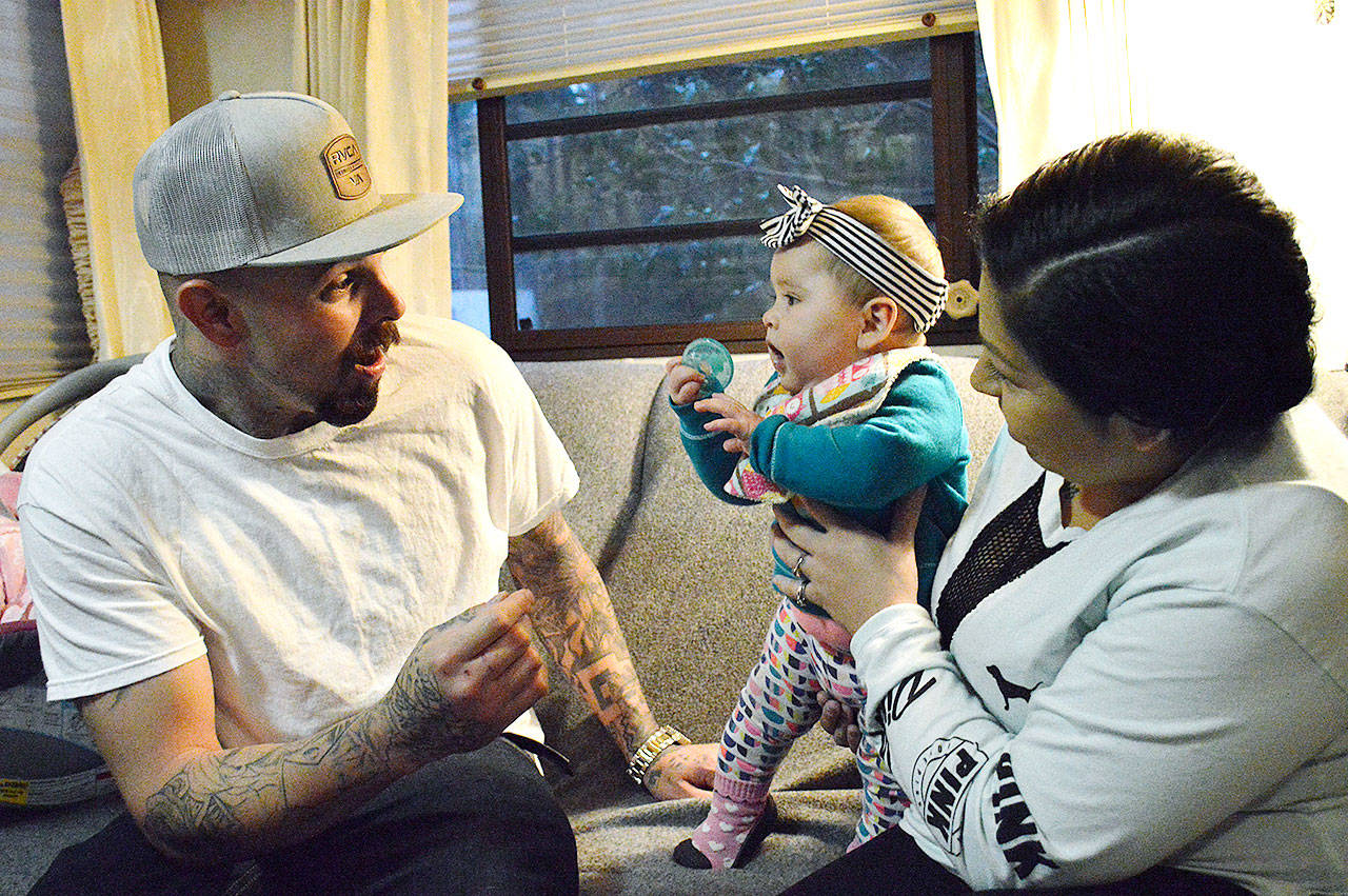 Daniel and Adriana Aivles play with their infant daughter Heaven in November 2018. At the time, the couple didn’t yet have custody of their older daughter and were still trying to complete their family treatment court obligations. The two recently graduated from the program. Photo by Laura Guido/Whidbey News-Times