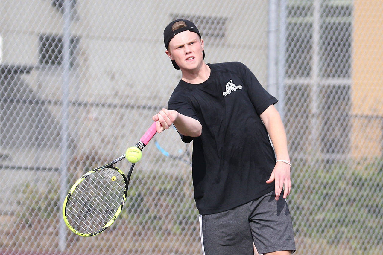Mason Grove swats a forehand in first doubles.(Photo by John Fisken)