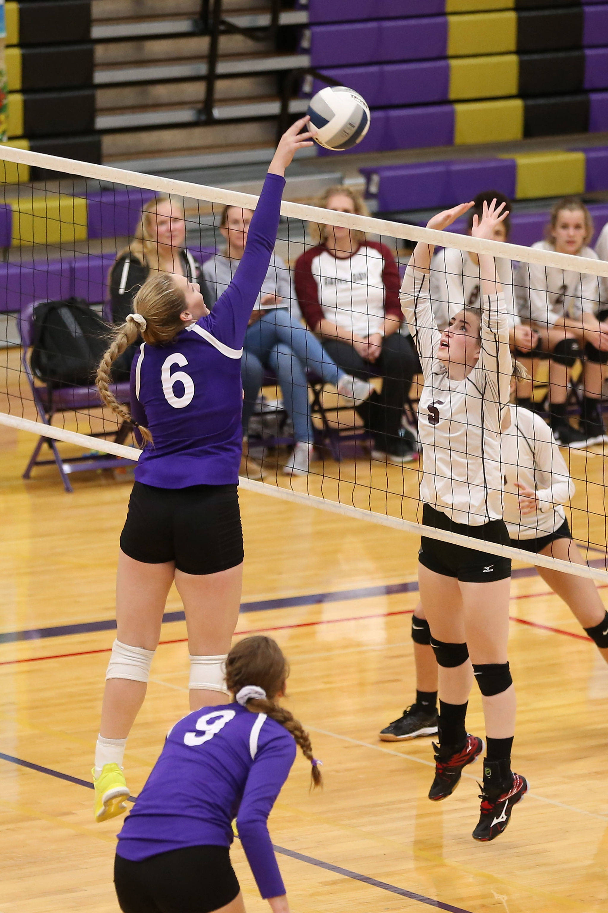 Oak Harbors Payton Parks, left, tips by the block of Cedarcrests Chloe Bigleman.(Photo by John Fisken)