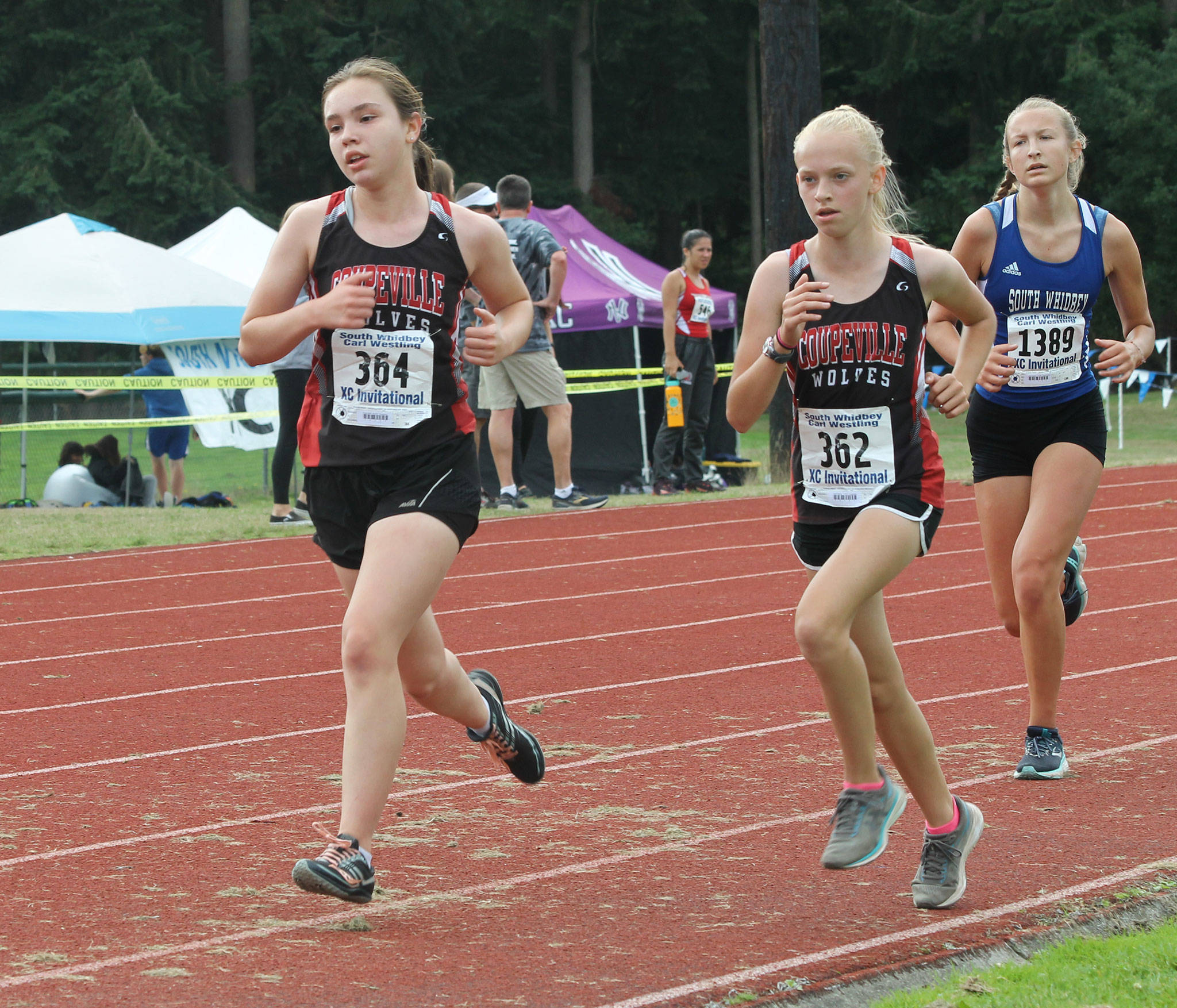 Alana Mihill and Claire Mayne pick up the pace as they run the final 200 meters.(Photo by Jim Waller/Whidbey News-Times)