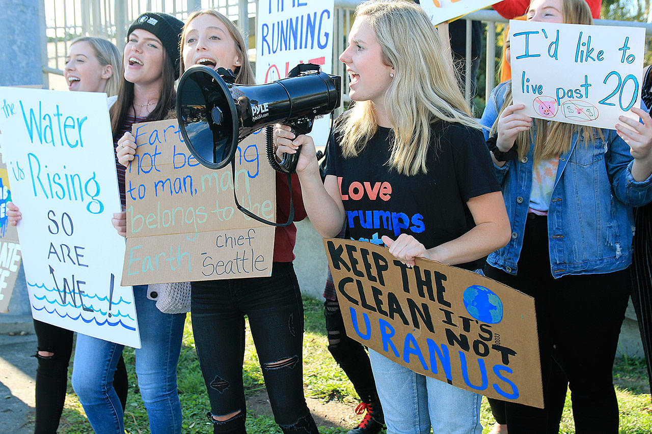 Oak Harbor High School student Ella Langrock, 17, leads a chant Friday afternoon during a climate protest in Coupeville. To Langrock’s right are Tara Sullivan, Gracie Hiteshew and Hannah Rogers. Photo by Laura Guido/Whidbey News-Times
