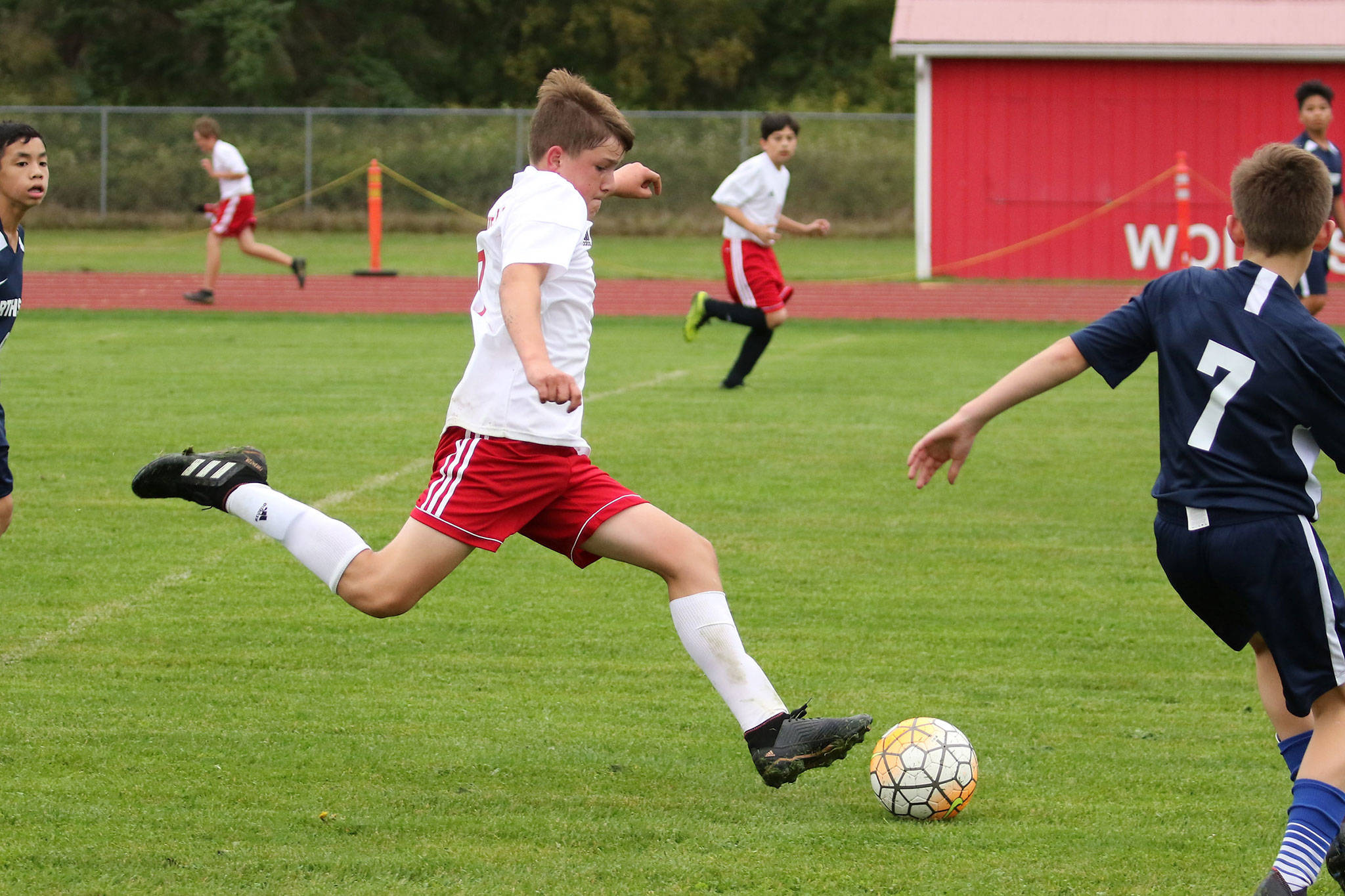 Coupeville’s Logan Downes gives the ball a boot in the Wolves first middle school soccer match Monday. (Photo by John Fisken)