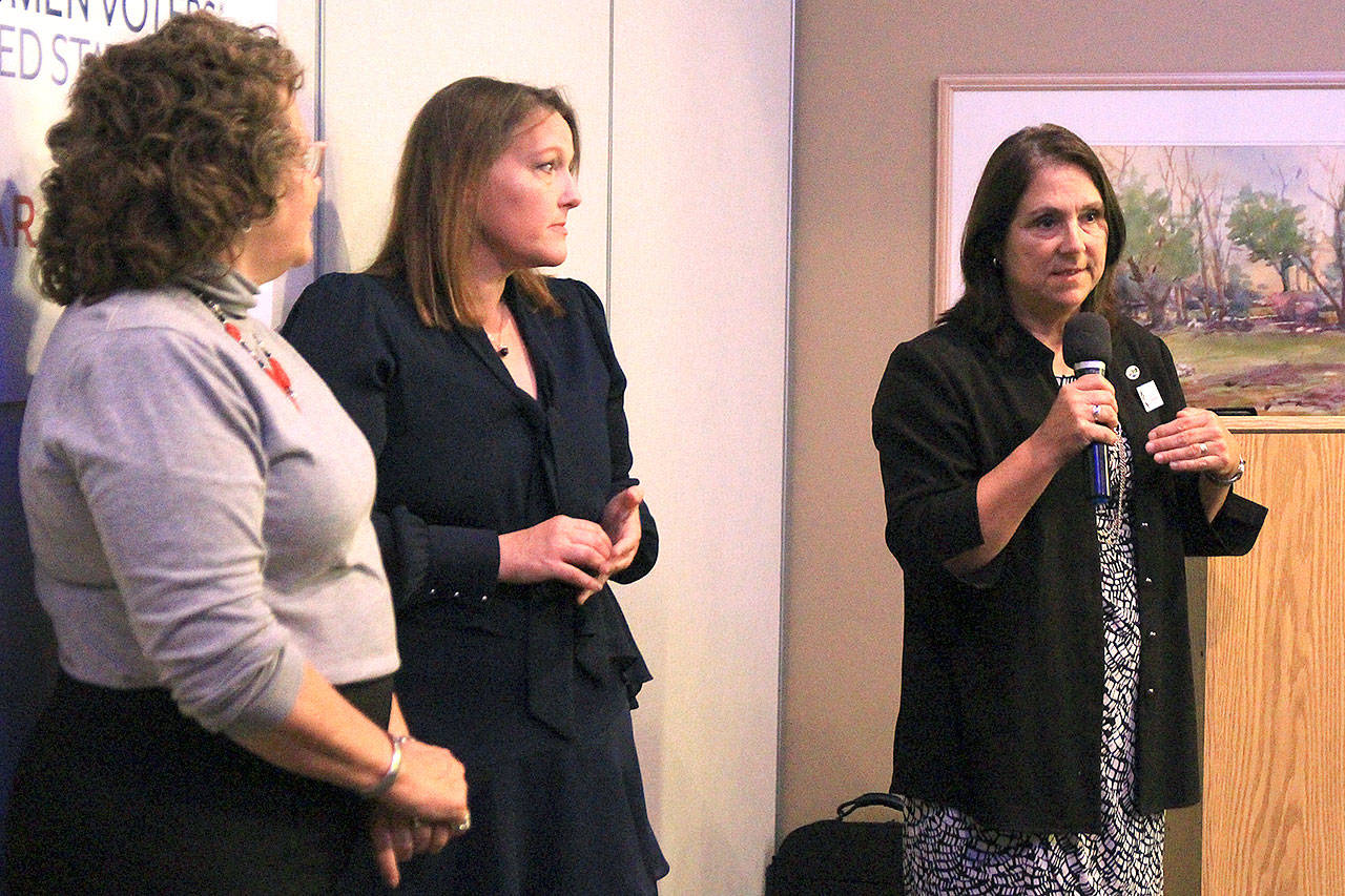 Island County Commissioner Helen Price Johnson speaks at a League of Women Voters event Thursday night at Whidbey Golf Club. She is joined by commissioners Jill Johnson, center, and Janet St. Clair, at left. Photo by Laura Guido/Whidbey News-Times
