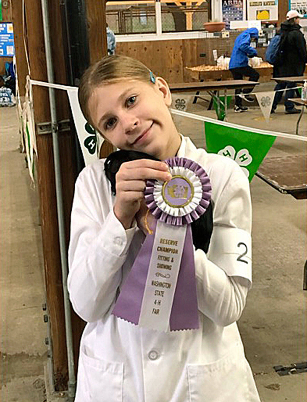Freeland resident Zoe Wilson and her guinea pig, Lola, show off the ribbon won at this years state fair. Photo provided