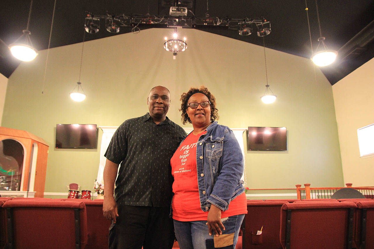 Pastors Fannie and Randy Dean stand among the pews in Mission Ministry Faith Center. They worked for two decades to get the church built.