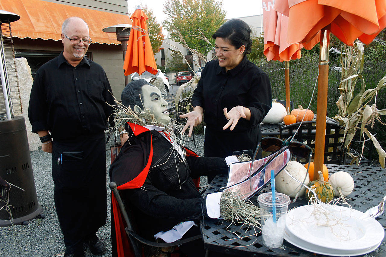 “May I take your order?” Nancy Hernandez asks “Dracula,” at Ciao Restaurant. He would like a Bloody Mary, she guessed, as the caped vampire took his time responding. She and Greg McCormick, left, of Ciao enjoyed some Halloween fun at the restaurant’s decorated outdoor seating area. Photos by Maria Matson/Whidbey News-Times