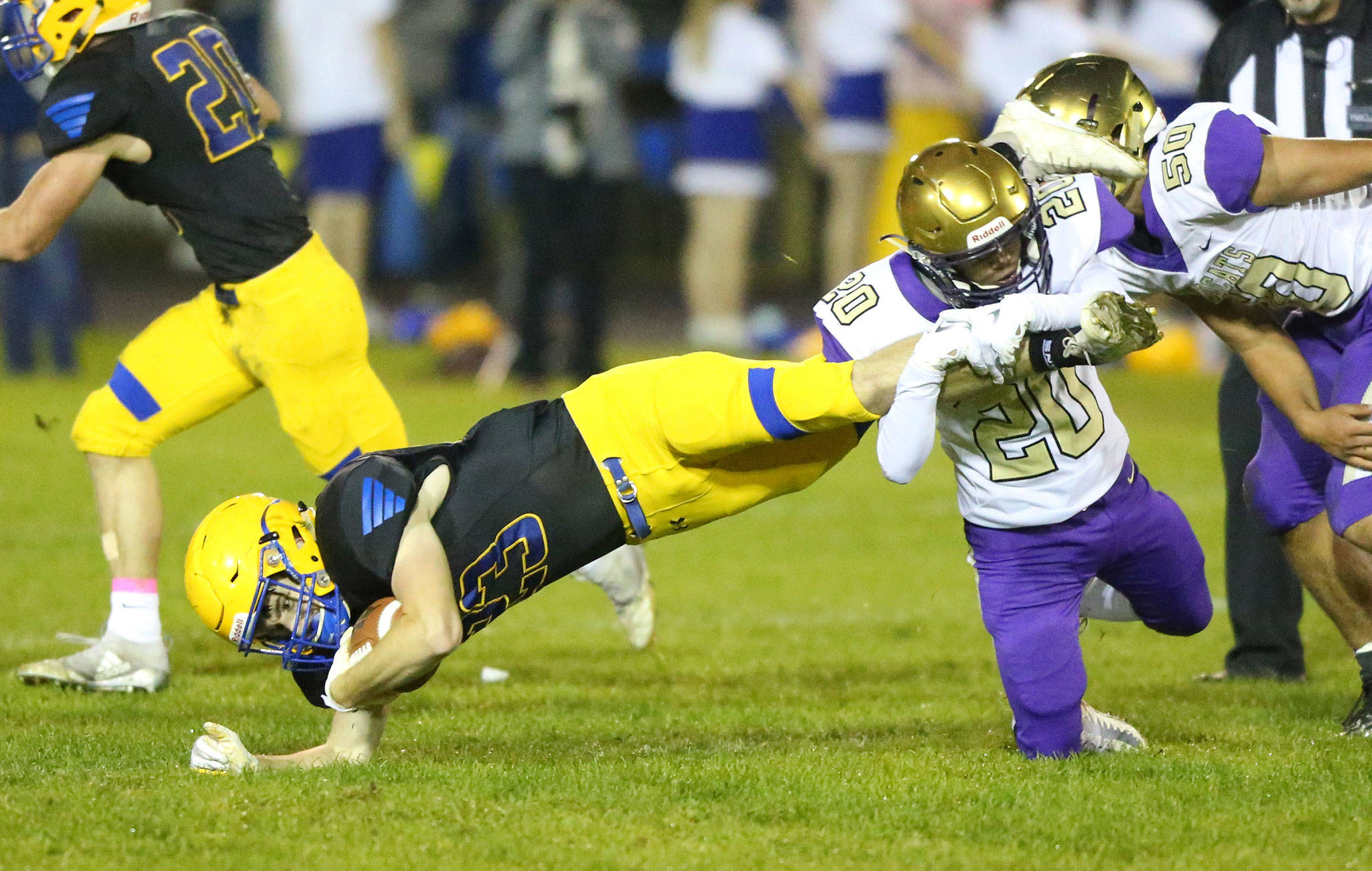 Oak Harbors Bennett Anderson (20) tackles Ferndales Andrew Monks.(Photo by John Fisken)