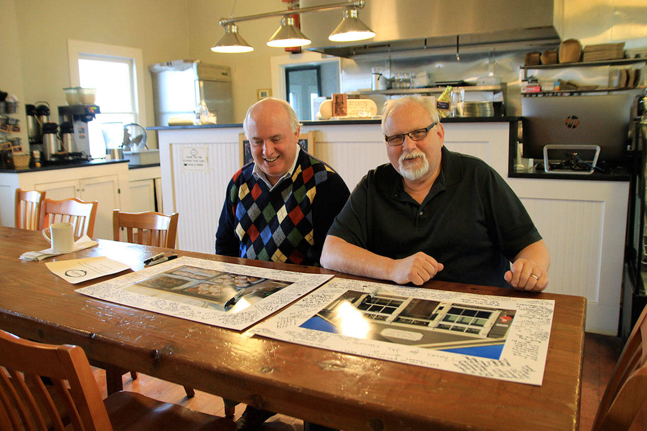 Jerry, left, and Doug Kroon look over messages and memories from the community. After 45 years, they will close their restaurant and bakery and move on to new adventures in their lives. Photo by Maria Matson/Whidbey News-Times