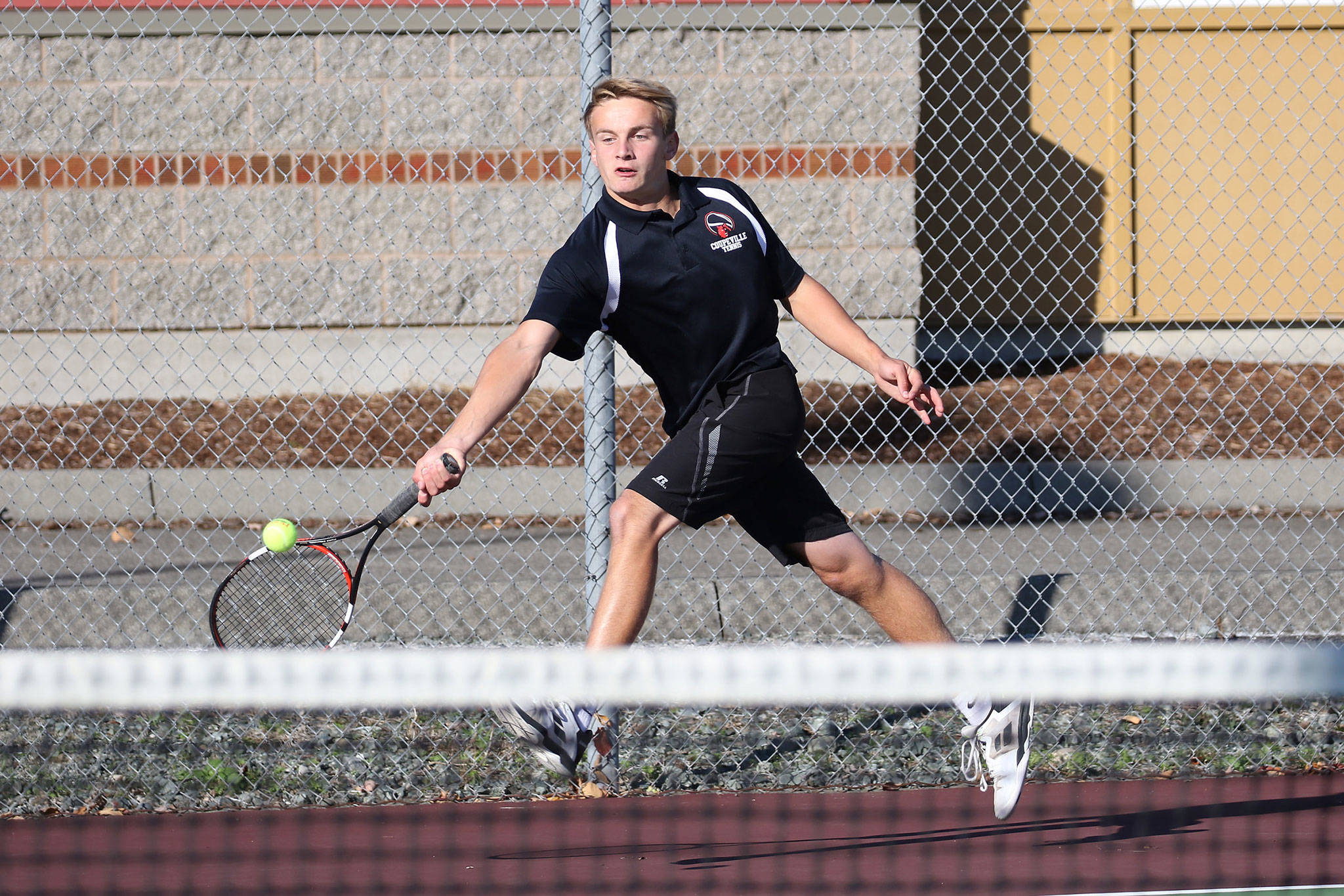 Coupeville’s Drake Borden returns a shot in his first singles with Wednesday. (Photo by John Fisken)