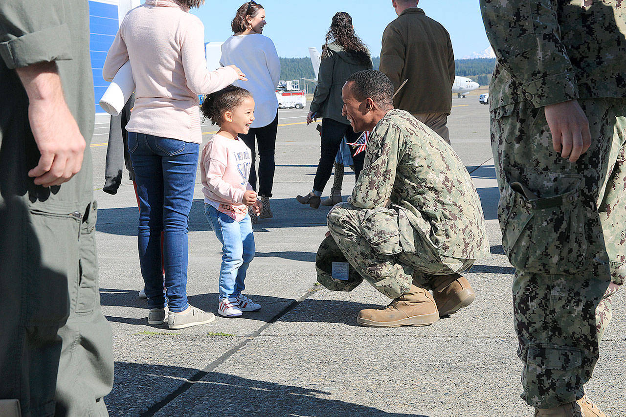Petty Officer 1st Class Jessie Ewing of VP-40 is greeted by his daughter Gala Ewing Thursday. He returned to Whidbey Island with the last active duty P-3C Orion.