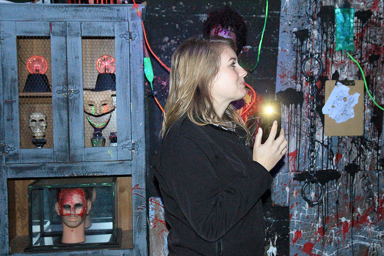Nikki Barone, unit director for the Oak Harbor Boys Girls Club, nervously travels through Frightville. The annual haunted house may be in its final year. Photo by Laura Guido/Whidbey News-Times
