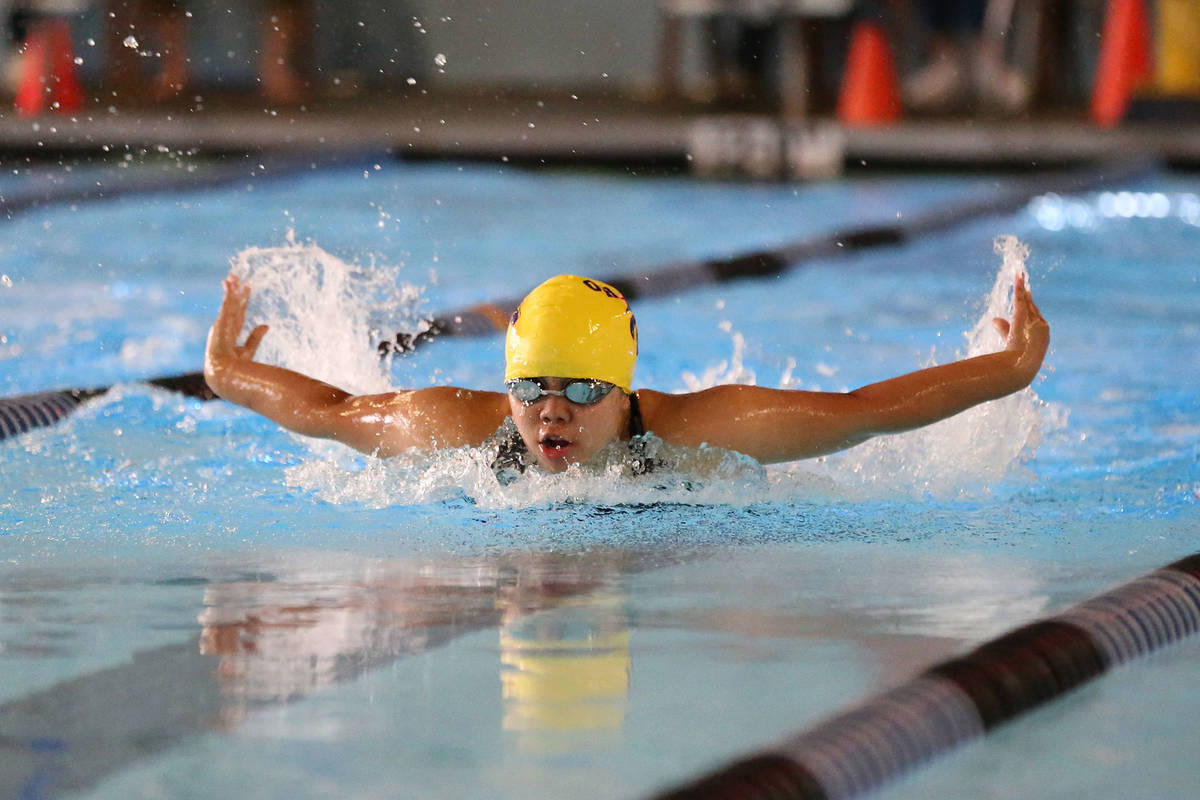 Casey Cabigting competes in the 100-meter butterfly for Oak Harbor in Tuesday’s meet. (Photo by John Fisken)