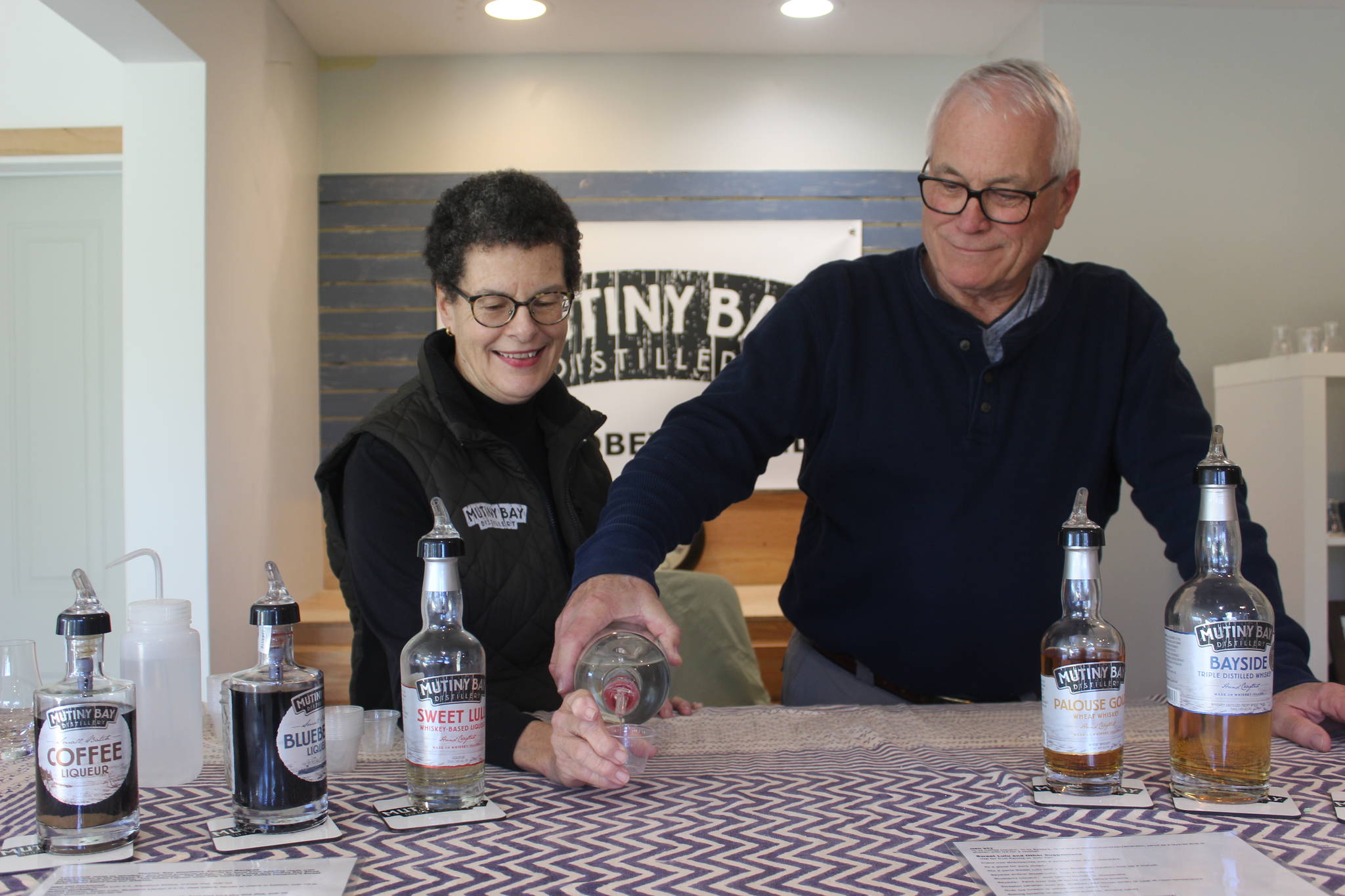 Photo by Wendy Leigh / Whidbey News Group                                <em>Rod and Kathy Stallman, owners of Mutiny Bay Distillers, pour hand-crafted small-batch whiskeys at the tasting bar.</em>