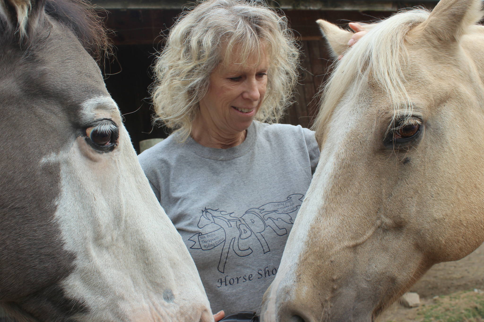 Marta Berry, board president at HOPE foundation, shows off Dusty, right, and Ryan, who will potentially become part of the HOPE family with proceeds from the Big Barn Bash fundraiser on Nov. 9. Photo by Wendy Leigh / South Whidbey Record
