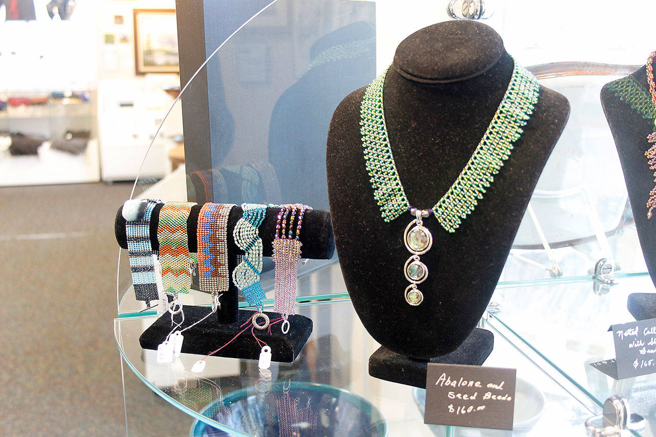 The gallery’s newest artist Shari Thompson weaves intricate patterns of seed beads into jewelry.