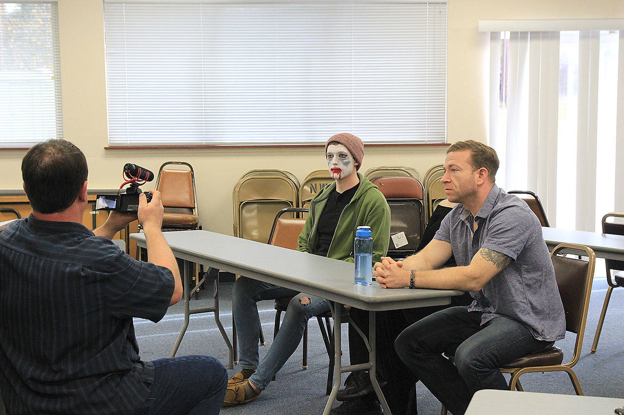 Jason Blaszkowski shoots a scene of Scared Stiff with Jared Maybury, left, and Patrick Cain. Photo by Laura Guido/Whidbey News-Times