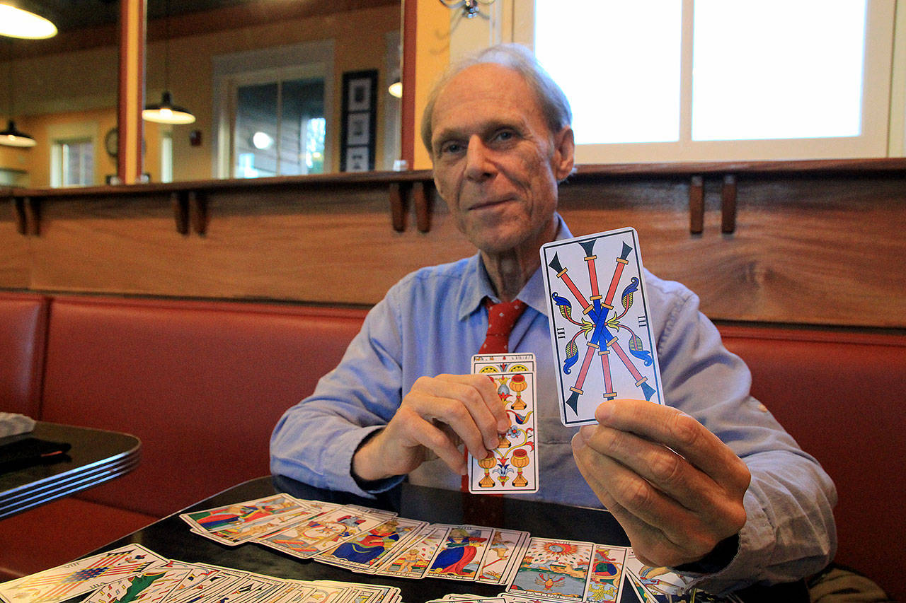 Photos by Kira Erickson/Whidbey News Group                                Gerry Reed holds up the third card in his tarot deck, a reissue of a deck from 1781.
