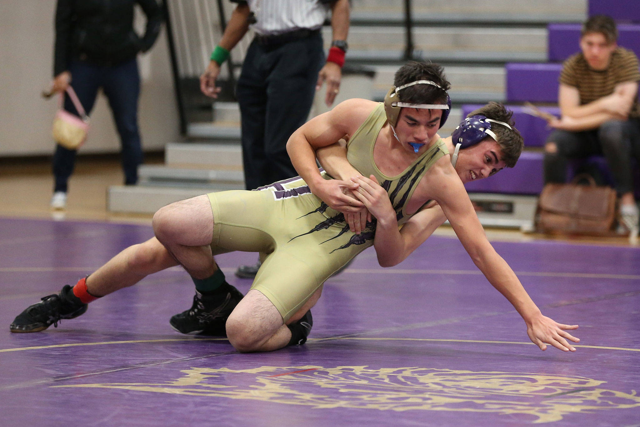 Jeremy Lujan and Miles Erikson tangle during Tuesday’s purple and gold scrimmage. (Photo by John Fisken)