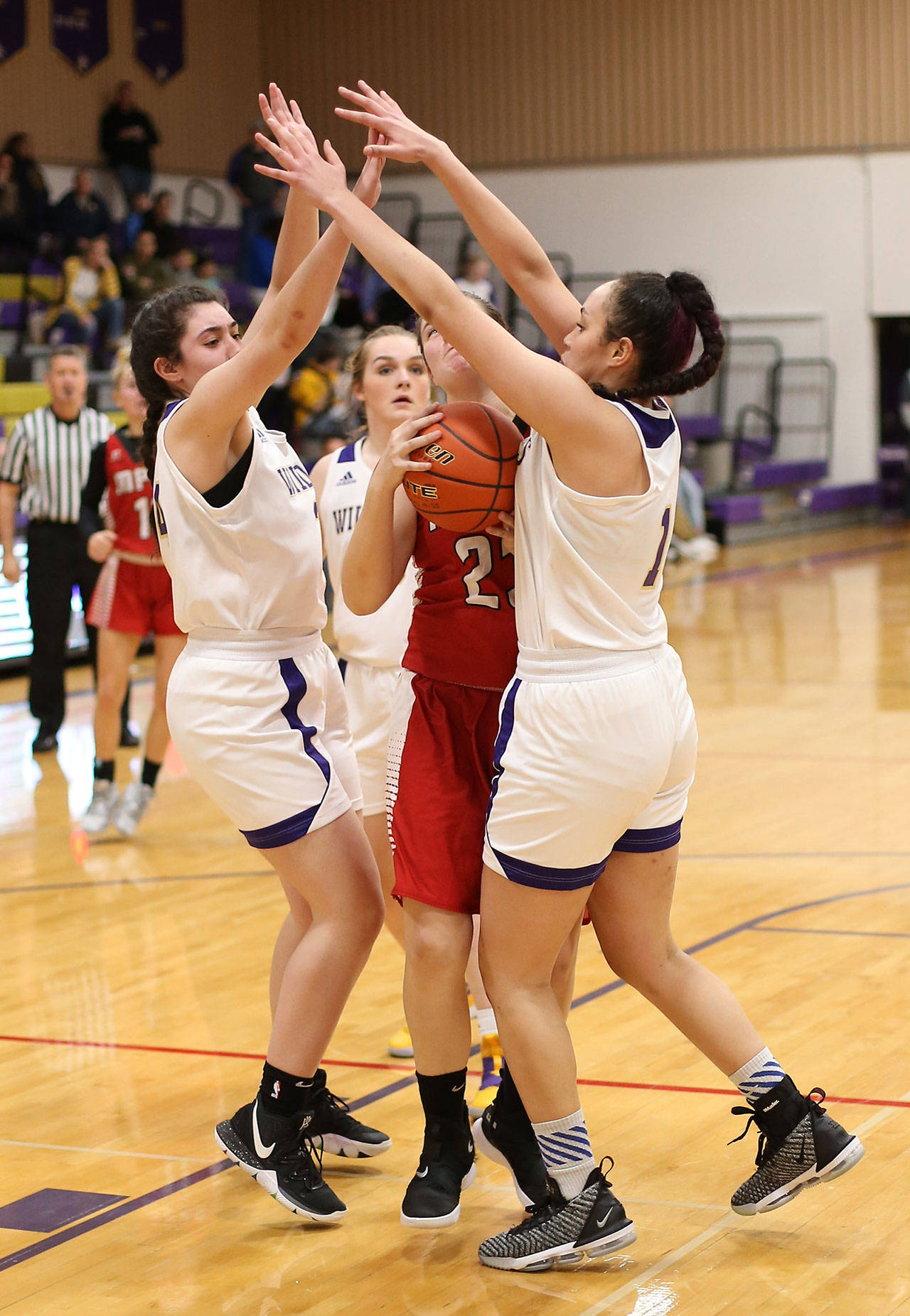 Oak Harbors Anna Jones, left, and Jasmine Ford double team Marysville-Pilchucks Alissa Edge.(Photo by John Fisken)