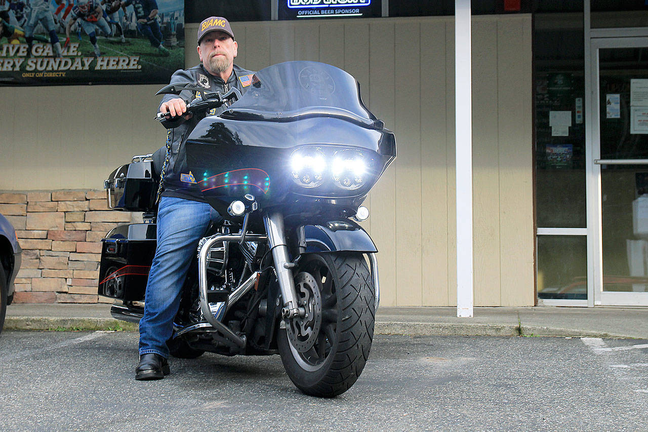 Mark “JarHead” Douglass, president of Brothers-in-Arms Motorcycle Club, North Puget Sound Chapter, parks his bike in front of All Sports Bar & Grill. The group will host its monthly raffle fundraiser Bike Night Jan. 8. Participants don’t need to ride motorcycles to donate. Photo by Laura Guido/Whidbey News-Times