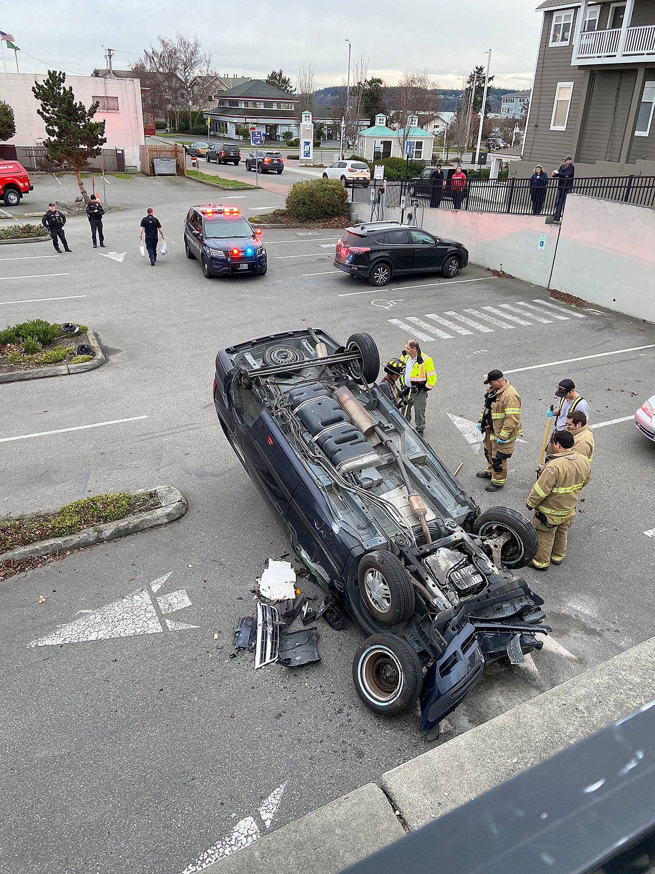 Photo by Bryan Fick                                A driver suffered minor injuries when her vehicle rolled down an embankment in downtown Oak Harbor.