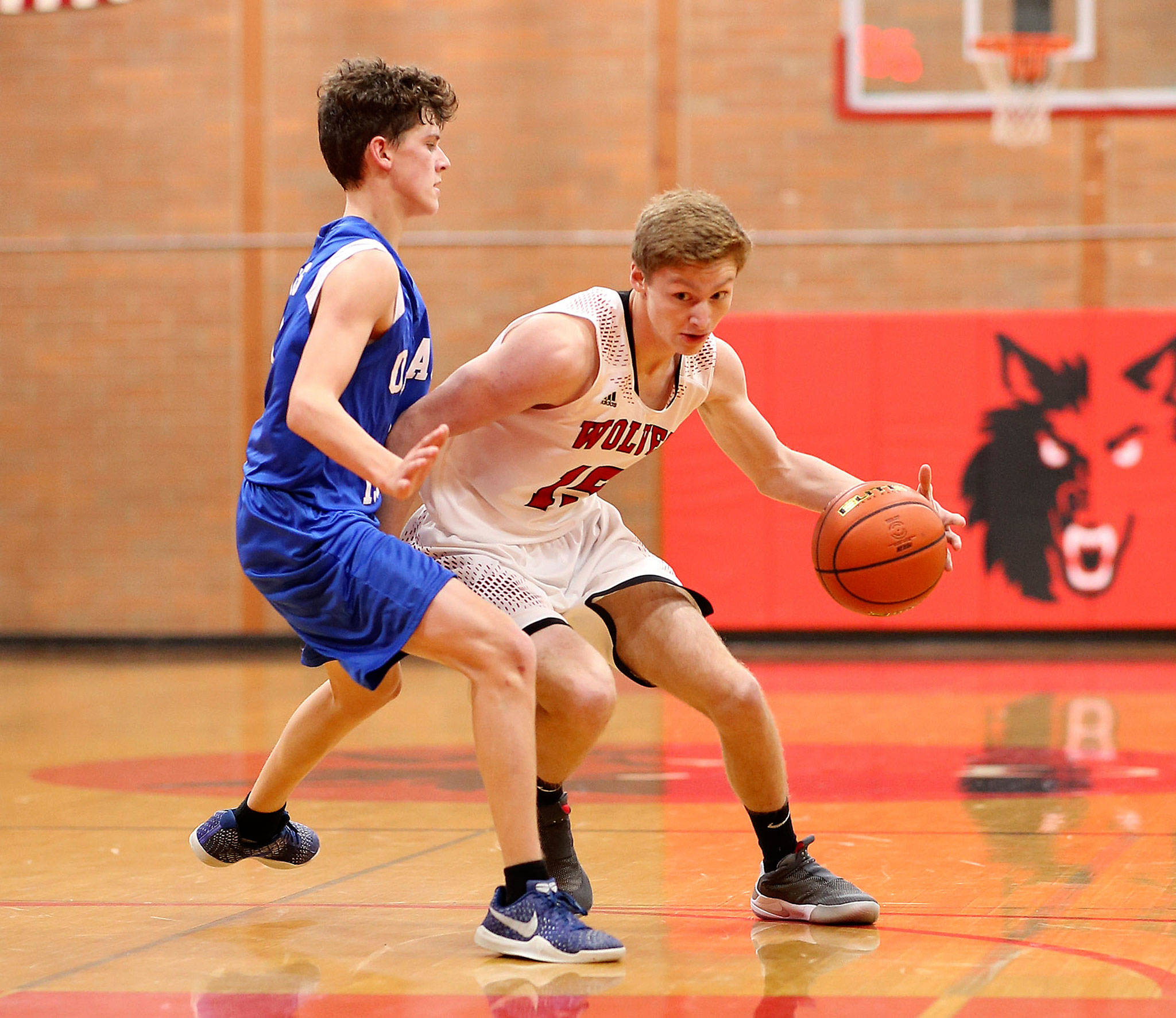 Coupeville’s Tucker Hall, right, dribbles against an Orcas Island defender in a non-league game earlier this season. Next school year the Wolves will compete in the same conference as the Vikings. (Photo by John Fisken)