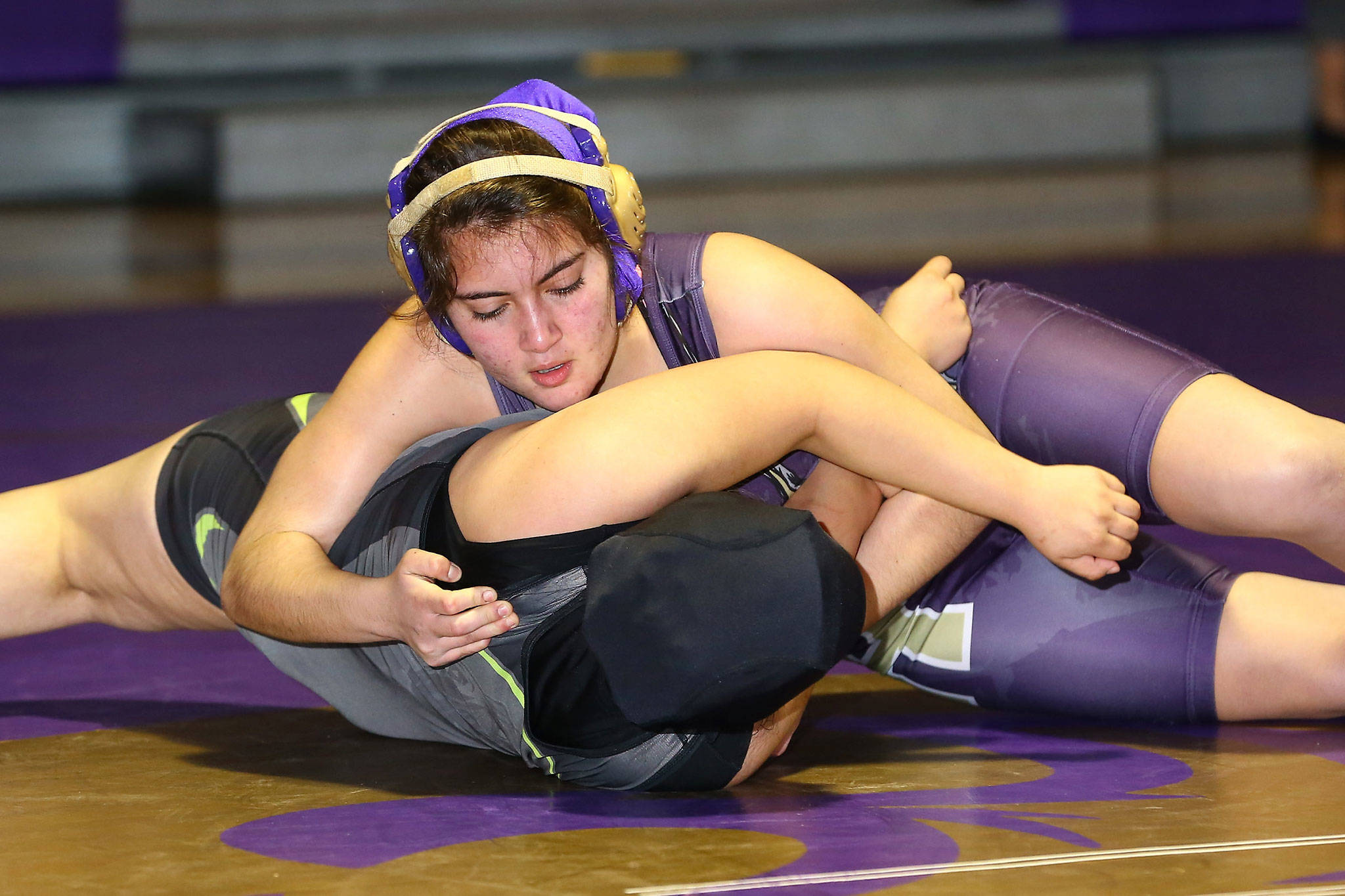 Oak Harbors Abigail Correa Cruz, top, pins her Lynden opponent Wednesday.(Photo by John Fisken)