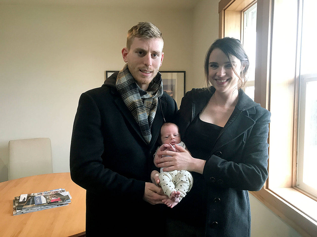 Parents Christian Carter and Leah Swearingen pose with Whidbeys first baby of 2020, Eli Cassius Carter, on Jan. 8 in Friday Harbor. Photo provided by Leah Swearingen