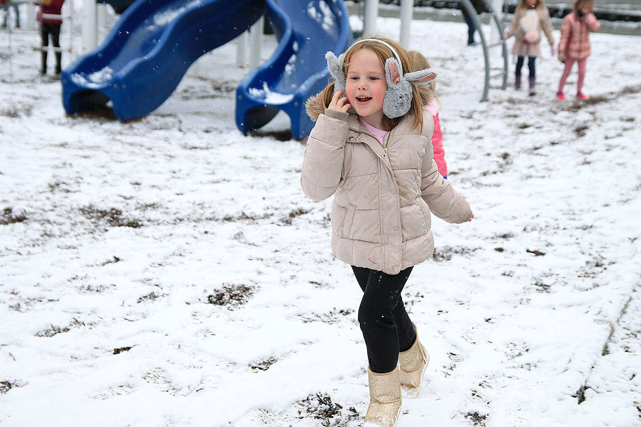 Lauretta Hodges dashes through the snow-covered playground Monday morning.