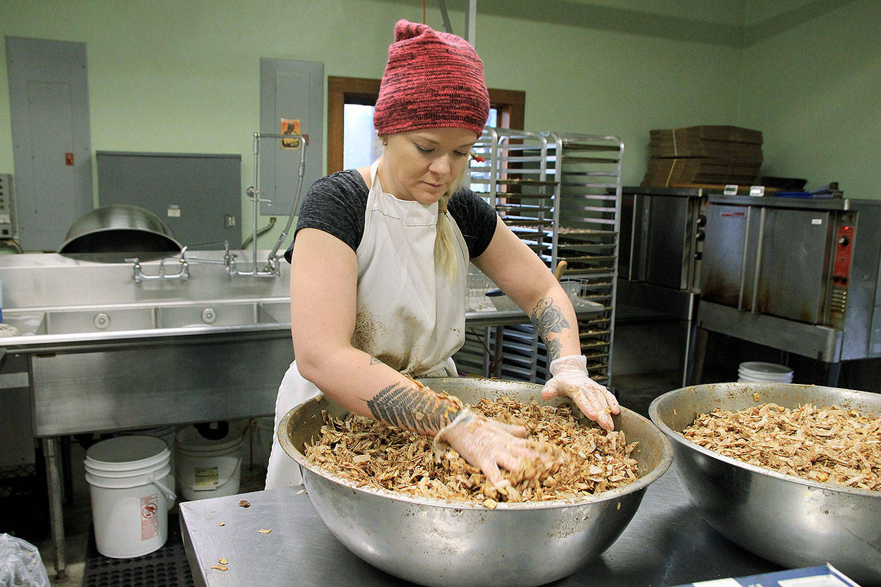 Photo by Kira Erickson/Whidbey News Group                                Kitchen Manager Hannah Hunsberger demonstrates how to mix the granola together before baking Jan. 9.