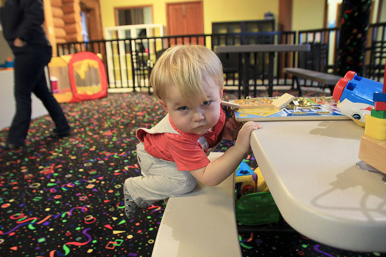 Photo by Laura Guido/Whidbey News-Times                                Nathanial Mildener, 15 months, stays busy at Oak Harbor Playtown.