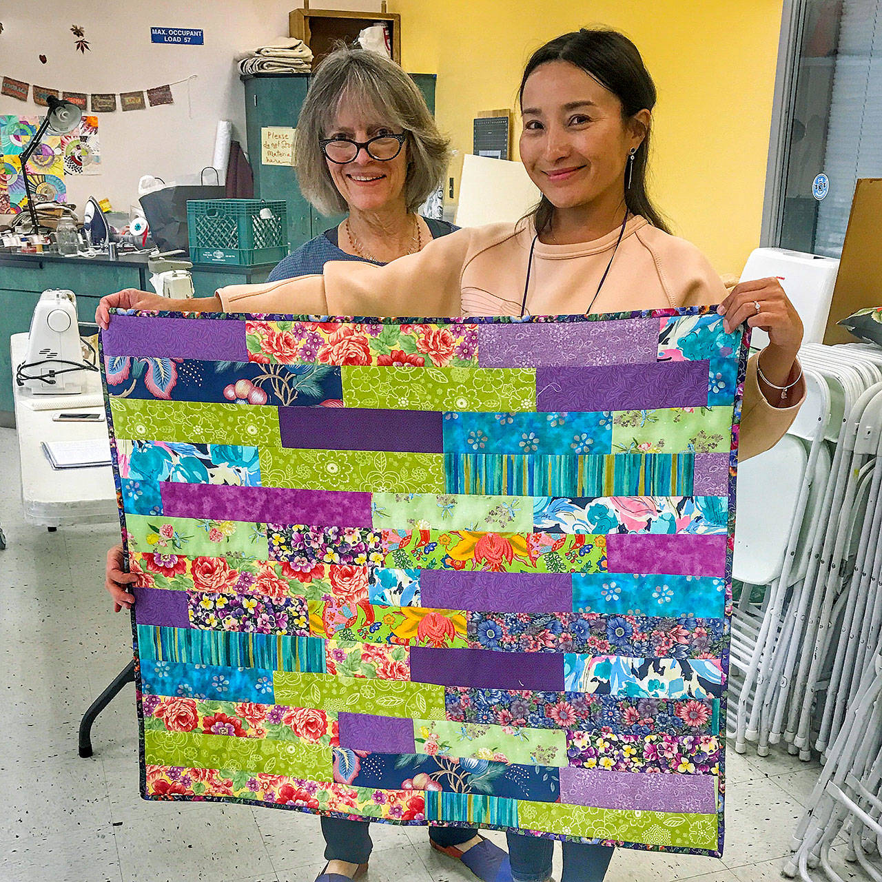 Photo courtesy of Luanne Seymour                                Darcy Sinclair, left, and Zhanar Tulegenovam display a blanket they made together.