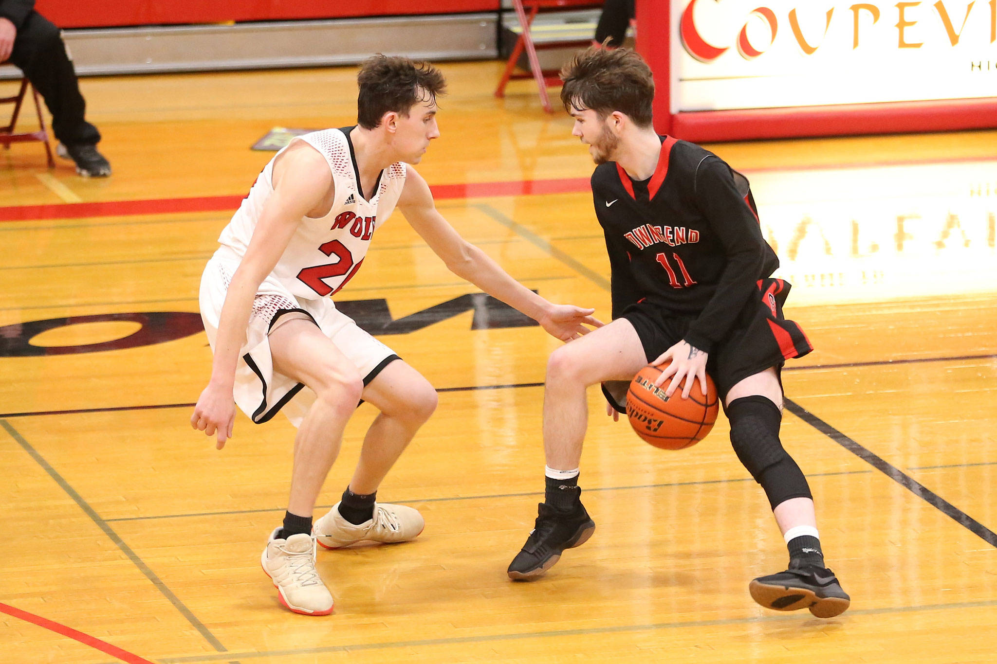 Coupevilles Xavier Murdy, left, defends Port Townsends Riley Yackulic in the Wolves win Saturday.(Photo by John Fisken)